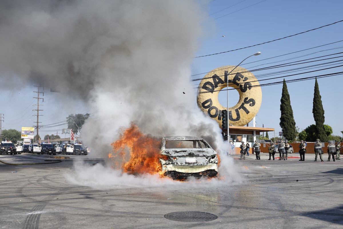 Los Angeles, CA - June 07: A car burns in the middle of the intersection of Atlantic Ave. and E Alondra Blvd. during ICE protests on Saturday, June 7, 2025 in Los Angeles, CA. (Carlin Stiehl / Los Angeles Times via Getty Images)