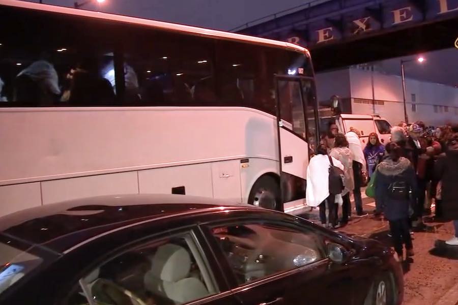 an image of migrants sent to Philadelphia on a bus from Texas governor Greg Abbott