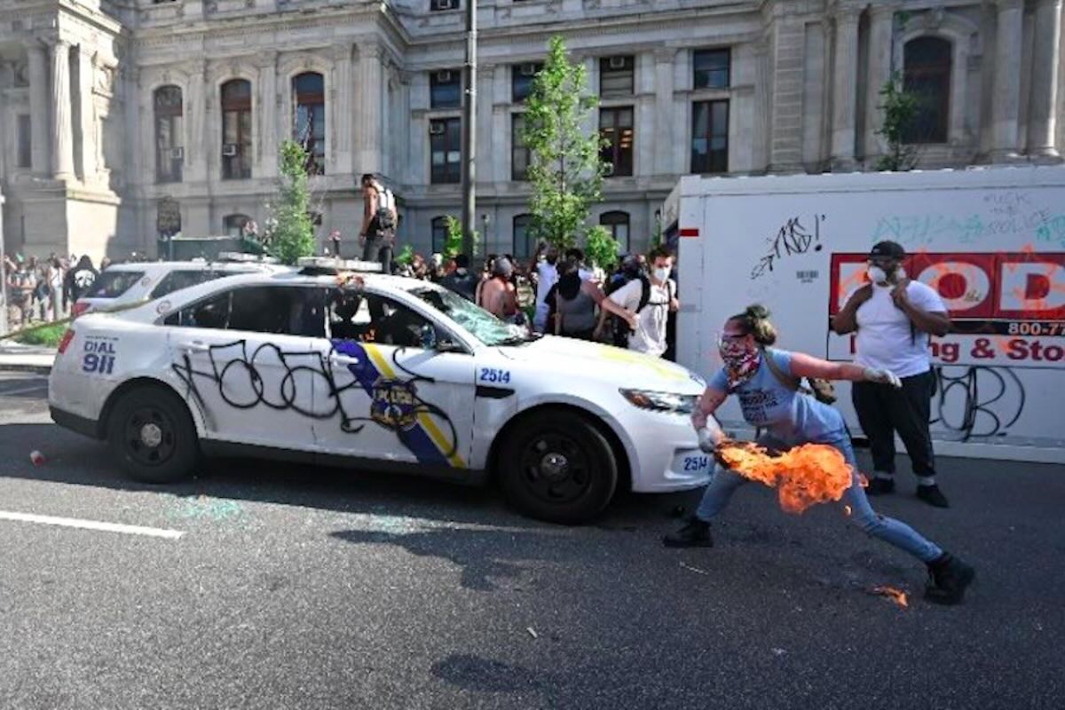 A Philadelphia protester firebombs a police vehicle in 2020, similar to some of the images we're seeing unfold in Los Angeles right now